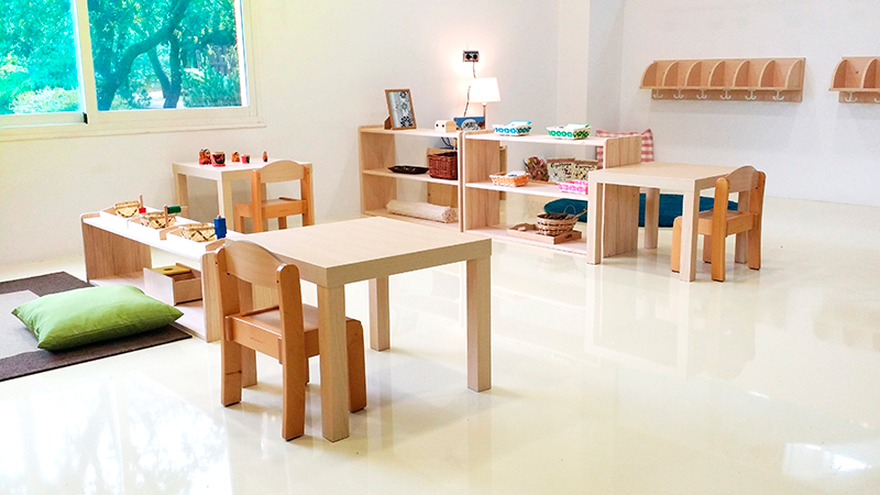 Montessori toddler classroom - look at those coat hooks, even lamps make the space inviting